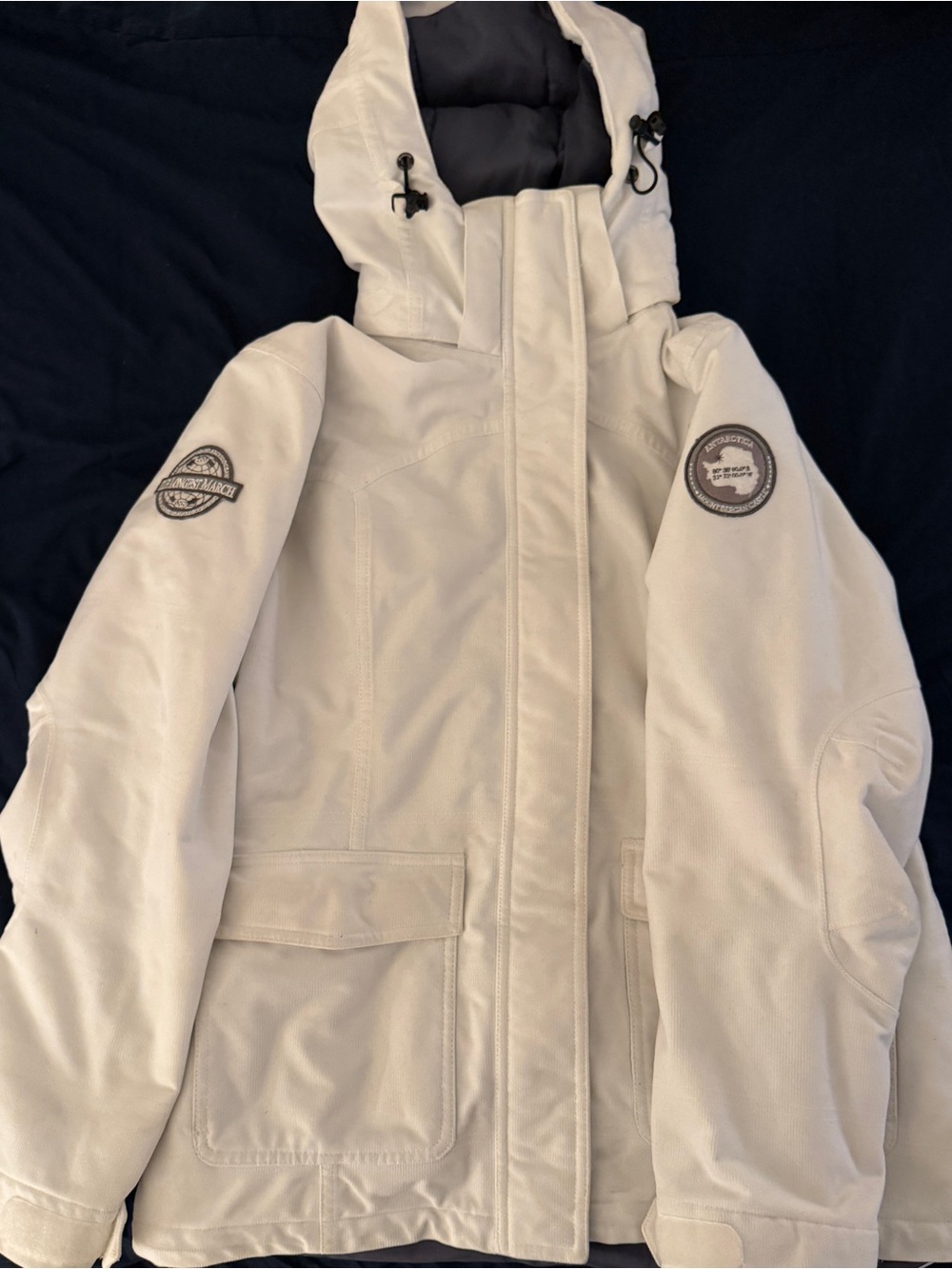 Insulated White Hooded Ski Jacket with Badge Accents